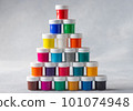 Pyramid of colorful gouache cans on gray background 101074948