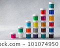 Multicolored gouache cans stacked as step stair 101074950