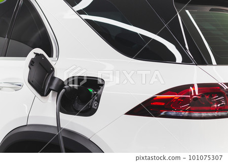 Electric car charging station. Hybrid car Electric charger station in the Car Park. Electric car charging station. Hybrid car Electric charger station in the Car Park. 101075307
