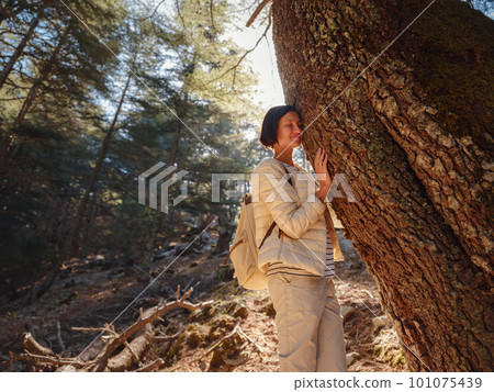 woman enjoys nature, beautiful forest in mountains woman enjoys nature, beautiful forest in mountains 101075439