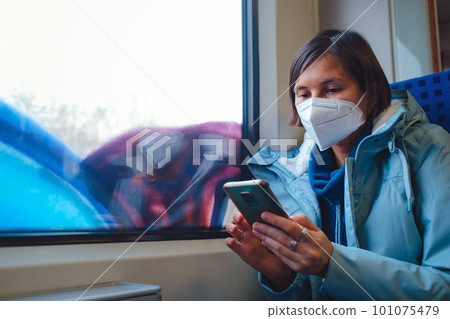 Asian Woman looking out of train window in winter day Asian Woman looking out of train window in winter day 101075479
