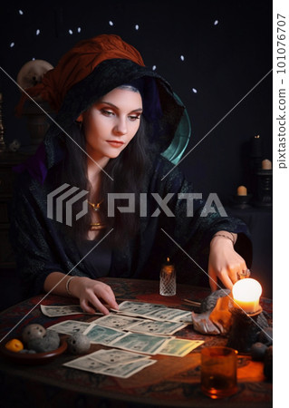 Young woman in witch costume with tarot cards. Halloween concept. Generative AI 101076707