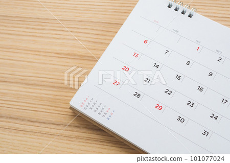calendar page on wood table background 101077024