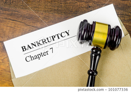 The Bankcrupty Chapter 7 text on Document form and Wooden Gavel on office desk. 101077336