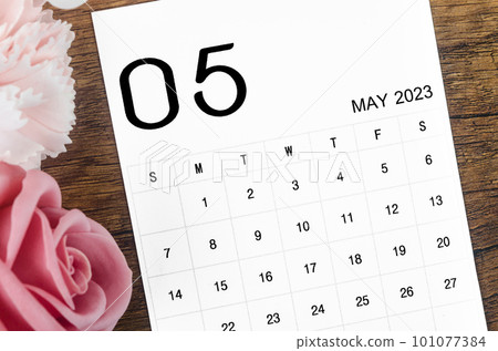 A May 2023 Monthly calendar for 2023 year with pink rose on wooden background. A May 2023 Monthly calendar for 2023 year with pink rose on wooden background. 101077384