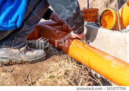 installation of a sewage plastic pipe during the construction of a house installation of a sewage plastic pipe during the construction of a house 101077706