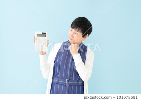 A woman with a calculator worries 101078681