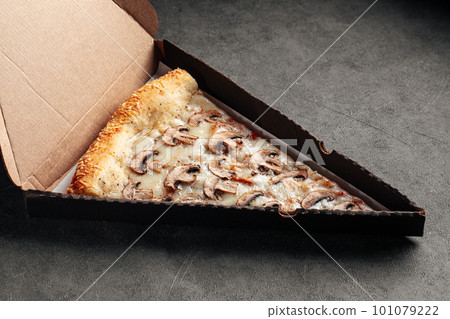 Take away box with slice of giant mushroom pizza 101079222