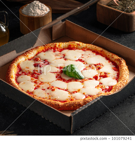 Take away backed margherita pizza with cheese Take away backed margherita pizza with cheese 101079241