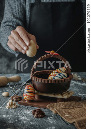 man puts a chocolate egg in a spanish mona de pascua 101079369