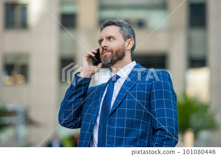 image of businessman call on phone and talk. businessman has phone call outdoor. 101080446