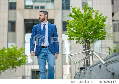 business manager walk on urban background. business manager wearing jacket in the street. 101080447