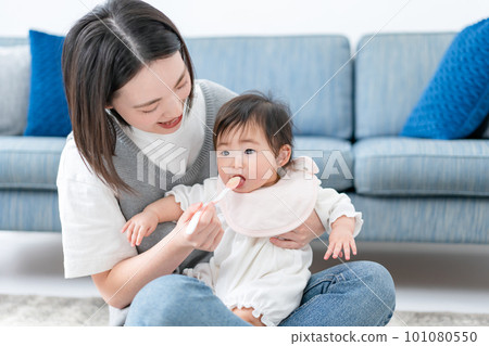 Baby eating baby food Baby eating baby food 101080550