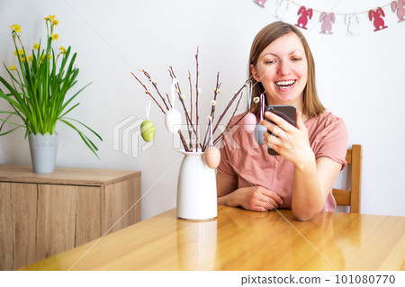 Beautiful smiling woman talk on a video call using a smartphone. Young girl communicating online. Beautiful smiling woman talk on a video call using a smartphone. Young girl communicating online. 101080770