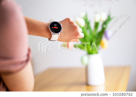Hand of woman wearing smart watch on the Easter background. Technology, business and people concept. Hand of woman wearing smart watch on the Easter background. Technology, business and people concept. 101080782