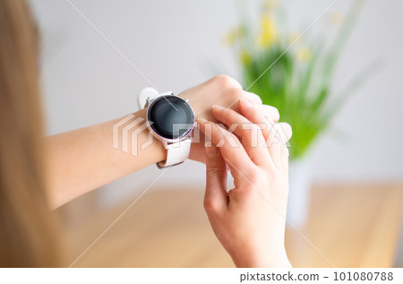 Hands of a woman wearing a smart watch. Technology, business and people concept. Modern lifestyle. Hands of a woman wearing a smart watch. Technology, business and people concept. Modern lifestyle. 101080788