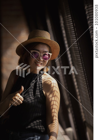 beautiful asian woman toothy smiling with happiness face standing beside metal curtain wall beautiful asian woman toothy smiling with happiness face standing beside metal curtain wall 101080938