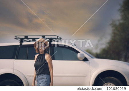 beautiful woman standing in front of suv car with toothy smiling happiness face beautiful woman standing in front of suv car with toothy smiling happiness face 101080939