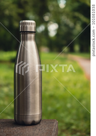 Water bottle. Reusable steel thermo water bottle on green grass. Sustainable lifestyle. Plastic free zero waste free living. Go green Environment protection Water bottle. Reusable steel thermo water bottle on green grass. Sustainable lifestyle. Plastic free zero waste free living. Go green Environment protection 101081038