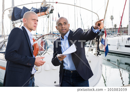men in suits buy and sell a yacht in the seaport men in suits buy and sell a yacht in the seaport 101081039