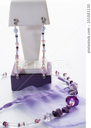 trendy author necklace with rarely gemstone charoite and earrings  around white background. fashion and handmade concept 101081130