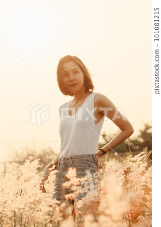 portrait of young woman with meadow view 101081215