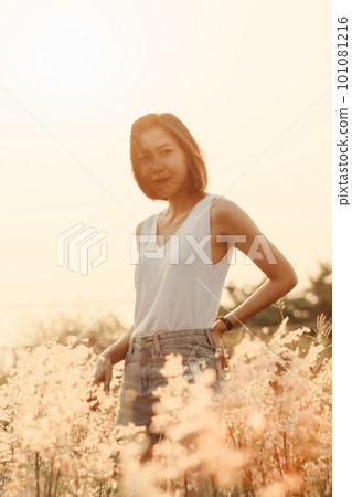portrait of young woman with meadow view portrait of young woman with meadow view 101081216