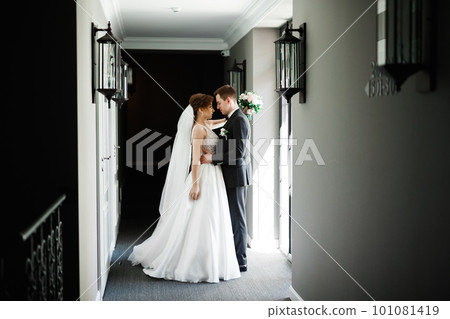 Gorgeous happy couple standing close to each other and looking in eyes 101081419