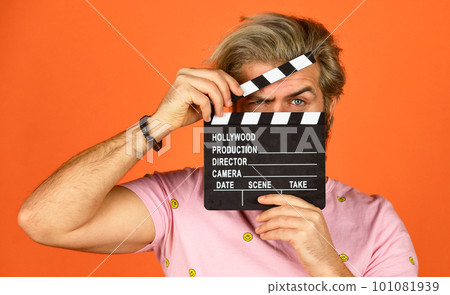 Cinema production. Creative producer. Bearded man hold movie clapper. Film maker. Clapperboard copy space. Comedy or drama. Watch movie. Film director. Actor casting. Shooting scene. Favorite series 101081939