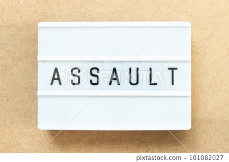 Lightbox with word assault on wood background Lightbox with word assault on wood background 101082027
