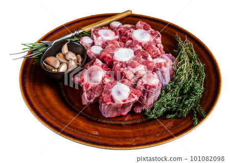 Fresh uncooked beef Oxtail cut Meat on rustic plate with herbs. Isolated on white background. Fresh uncooked beef Oxtail cut Meat on rustic plate with herbs. Isolated on white background. 101082098