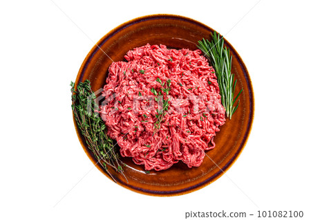 Raw mince beef and lamb meat on a rustic plate with herbs. Isolated on white background. Raw mince beef and lamb meat on a rustic plate with herbs. Isolated on white background. 101082100