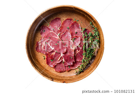 Pastrami slices, dried beef meat with herbs in wooden plate. Isolated on white background. 101082131