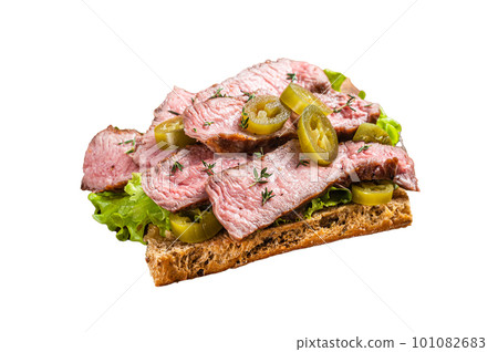 Griiled Steak sandwich with sliced beef, rocket and vegetables on bread. Isolated on white background. Griiled Steak sandwich with sliced beef, rocket and vegetables on bread. Isolated on white background. 101082683