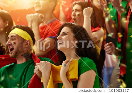 Portugal football, soccer fans cheering their team at stadium. Excited fans cheering a goal, supporting favourite players 101083127