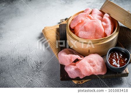 Indonesian prawn shrimp crackers or chips with sauce. White background. Top view. Copy space Indonesian prawn shrimp crackers or chips with sauce. White background. Top view. Copy space 101083418