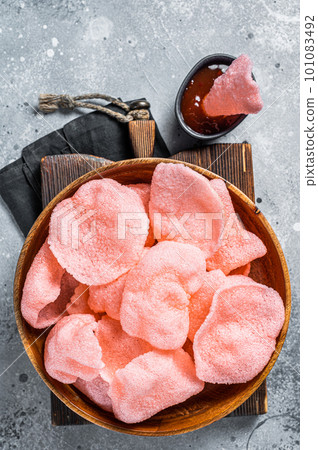 Crunchy kerupuk prawn shrimp crackers, chips. Gray background. Top view 101083492