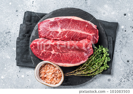 Raw top blade flat Iron beef organic meat. Gray background. Top View Raw top blade flat Iron beef organic meat. Gray background. Top View 101083503