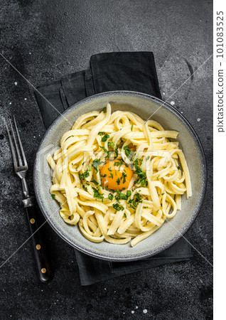 Traditional Bavarian Spaetzle egg Noodles with Butter and Parsley. Black background. Top view Traditional Bavarian Spaetzle egg Noodles with Butter and Parsley. Black background. Top view 101083525