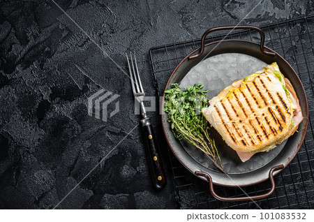 Club sandwich panini with Prosciutto ham. Black background. top view. copy space Club sandwich panini with Prosciutto ham. Black background. top view. copy space 101083532