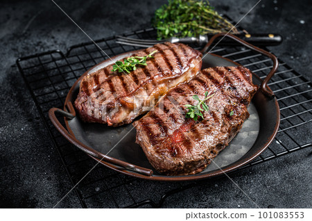Grilled Top Blade or flat iron beef meat steaks. Black background. Top View 101083553