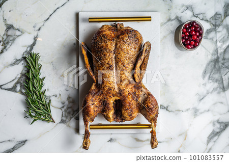 Roasted duck stuffed with baked apples, festive christmas recipe. Marble background. Top view Roasted duck stuffed with baked apples, festive christmas recipe. Marble background. Top view 101083557