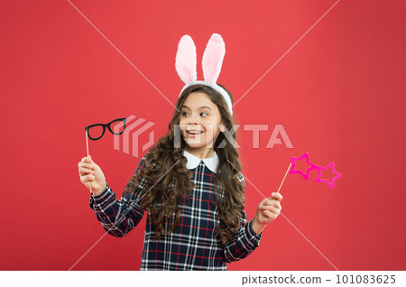 Eyewear booth props. Little cute bunny. Having fun. Schoolgirl bunny ears. Girl in Easter bunny at egg hunt. Party and social event. Family holiday. Traditional party activities. Smart bunny Eyewear booth props. Little cute bunny. Having fun. Schoolgirl bunny ears. Girl in Easter bunny at egg hunt. Party and social event. Family holiday. Traditional party activities. Smart bunny 101083625