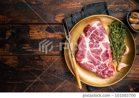 Marble pork steak, raw neck meat with thyme. Wooden background. Top view. Copy space Marble pork steak, raw neck meat with thyme. Wooden background. Top view. Copy space 101083700