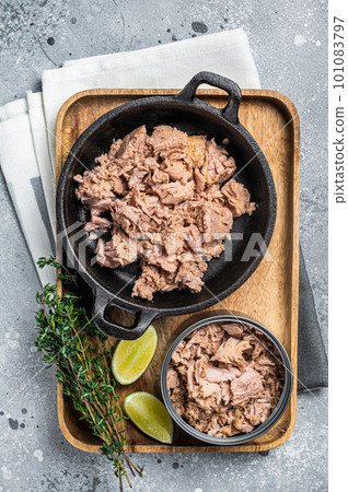 Canned tuna fillet meat ready for cooking. Gray background. Top view Canned tuna fillet meat ready for cooking. Gray background. Top view 101083797