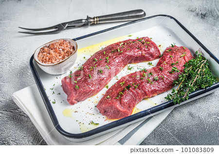 Fresh lamb sirloin meat, Mutton tenderloin fillet with herbs and spices ready for cooking. White background. Top view 101083809