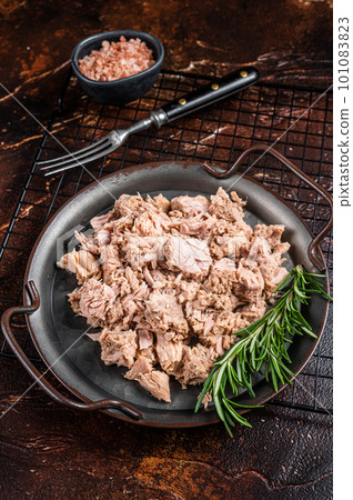 Canned tuna with fresh herbs ready for eat. Dark background. Top view 101083823