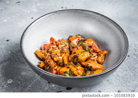 Chinese Sweet and Sour Pork guo bao rou in a bowl. Gray background. Top view Chinese Sweet and Sour Pork guo bao rou in a bowl. Gray background. Top view 101083910