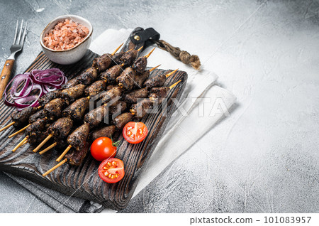 Chicken hearts grilled on skewers with herbs and spices. White background. Top view. Copy space 101083957