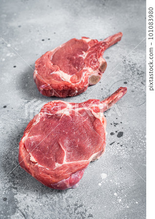 Raw Tomahawk beef (veal) steak on butcher table. Gray background. Top view 101083980